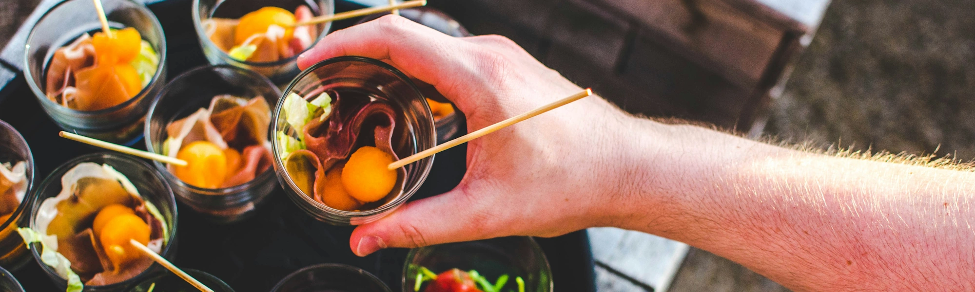 A hand serving cocktails